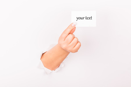 wall hand holding business cardの写真素材