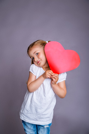 smiling little girl with gift present for mother father dayの写真素材
