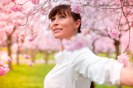 happy joyful relaxing female in romantic gardenの写真素材