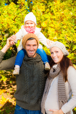 family in autumn park smiling の写真素材