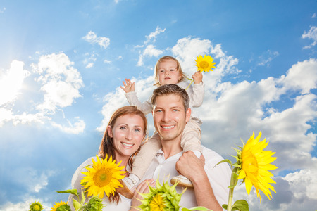 blue sky family in sunflower fieldの写真素材