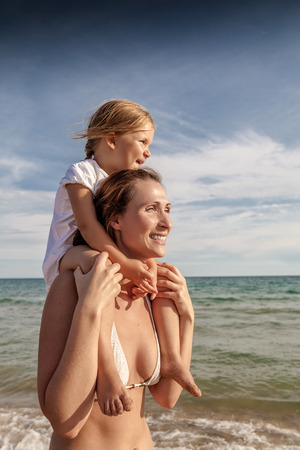 leisure lifestyle walking with flying kid on backの写真素材