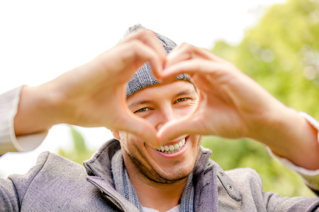 happy carefree male outdoors smiling green spring の写真素材