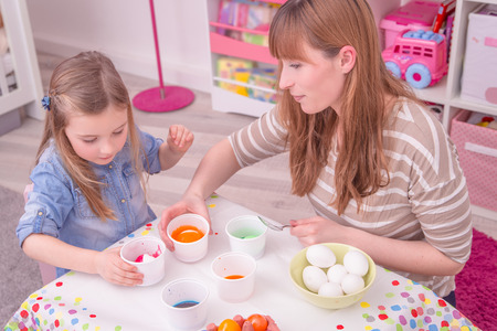 coloring easter eggs at homeの写真素材