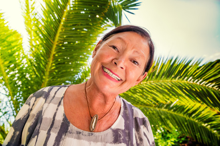 Retired female smiling on summer dayの写真素材