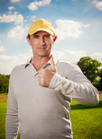 smiling man standing outdoors positive gestureの写真素材