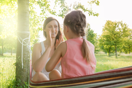 mother playing with daughter hammockの写真素材