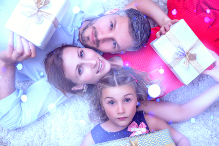 parents with daughter and christmas presentsの写真素材