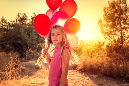 portrait if little girl with balloonsの写真素材
