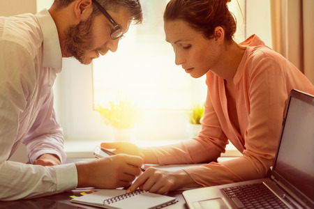 business couple working sunflare behindの写真素材