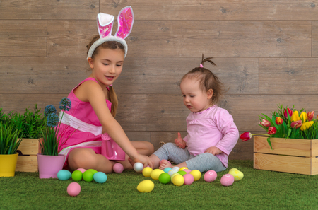 easter childs playing with eggsの写真素材