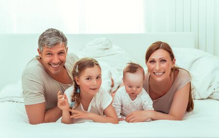 happy family at home in bedroom