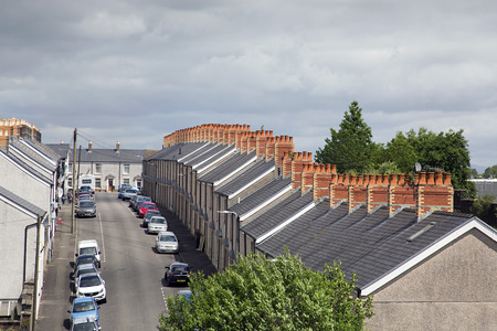 Swansea, UK: June 2017: Traditional terraced houses in a Swansea suburb. Overview of roofs and...