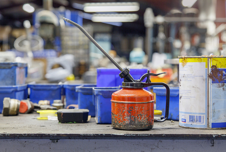 Birmingham, UK: December 27, 2017: Small oil can and plastic boxes on a workbench in a factory unit.のeditorial素材