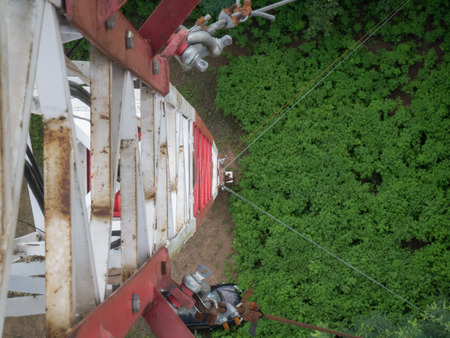 A deep view of a construction worker from a steel internet towerの写真素材