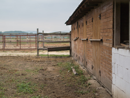 wooden brown barn in the yardの写真素材