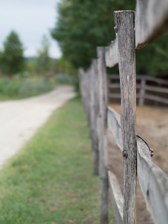 sandy road with wooden fenceの写真素材