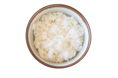 Top view rice in a bowl on white backgroundの写真素材
