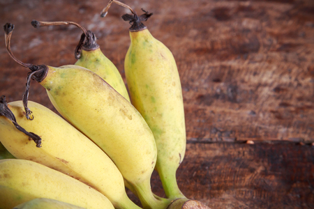 Yellow bananas group on wooden backgroundの写真素材