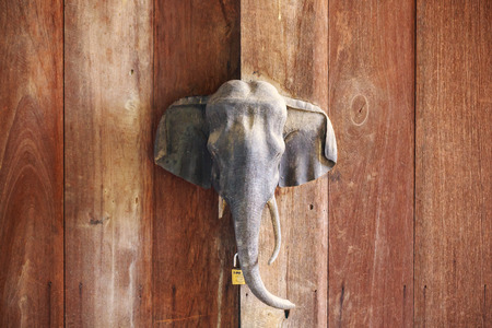 sculpture wood elephant handle door on wooden background