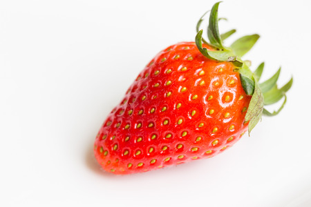fresh ripe red strawberries in white plateの写真素材