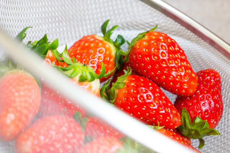 fresh ripe red strawberries in white bowl