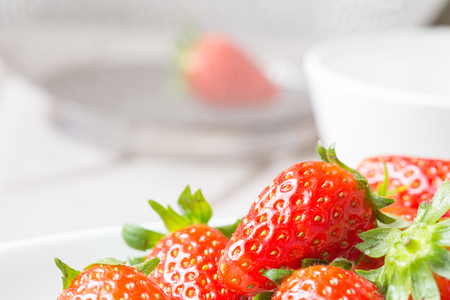 fresh ripe red strawberries in white plateの写真素材