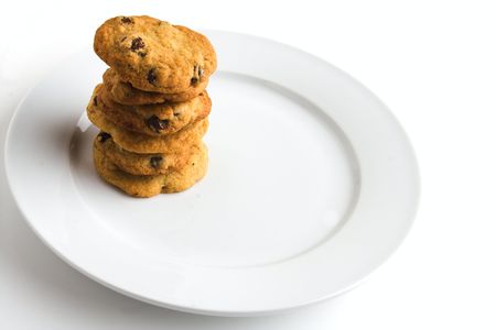 stack of homemade chocolate chip cookies on white plateの写真素材