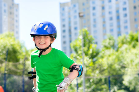 happy smiling boy in sports helmet doing active sport in summerの写真素材