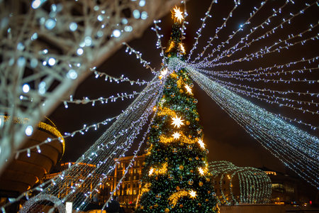 New Year, Christmas tree with lights, gold decorations in the evening on Paveletskaya Square in...