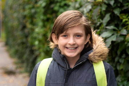 Portrait of a cute young boy smiling at camera in the park