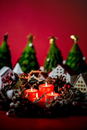 Christmas decoration with candles and fir tree on red background. Copy space.の写真素材