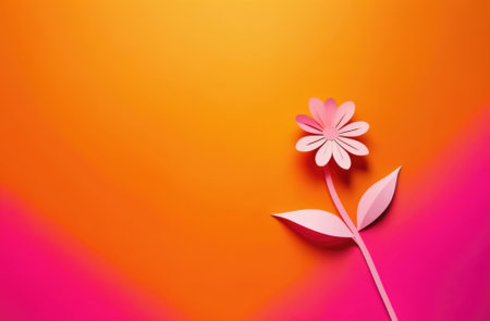 Paper flower on orange and pink background, copy space for your textの素材