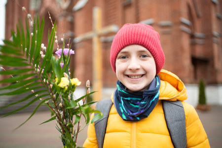 Portrait of a smiling little boy in a yellow jacket and a pink hat