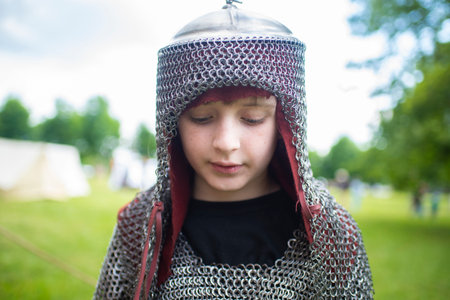 Young boy in medieval costume with chain mail in the park. Selective focusの写真素材