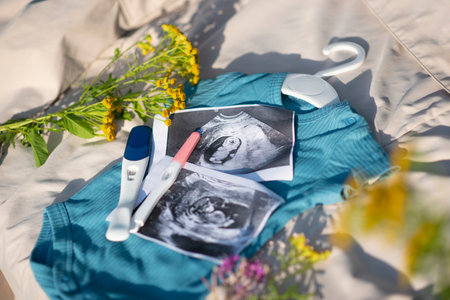 ultrasound photo of baby, fetus and pregnancy test on blue bodysuit for newborn