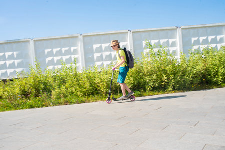Person riding a scooter on a sunny day.の写真素材