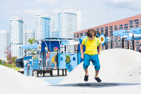 A boy jumps on a trampoline at a playground in Khodynskoe Pole Park in Moscow.の写真素材