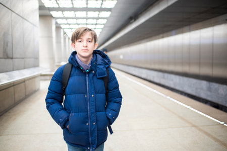 Portrait of a boy in a blue jacket in the subway stationの写真素材