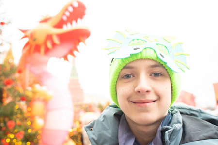 Portrait of a European teenager boy on Chinese New Year. Child at a festival decorated for the Lunar New Year in Moscow.の写真素材