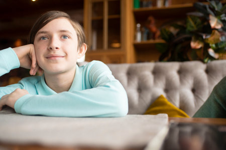 portrait of happy boy sitting at tableの写真素材