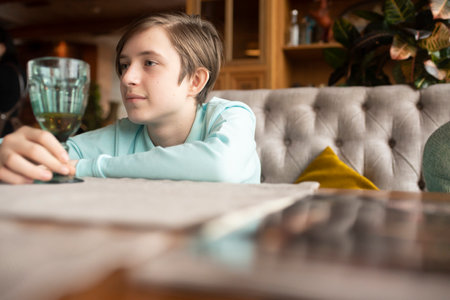 portrait of boy in blue shirt sitting at tableの写真素材