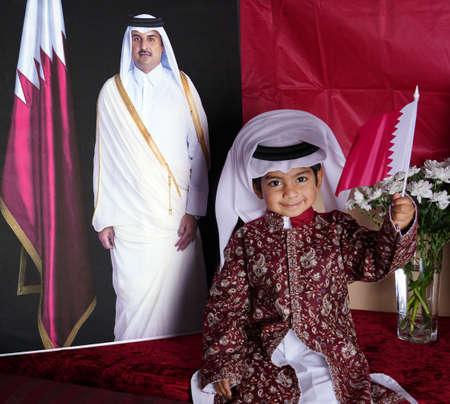 Qatary kids with treditional dress and flag -Doha QATAR 10-10-2020