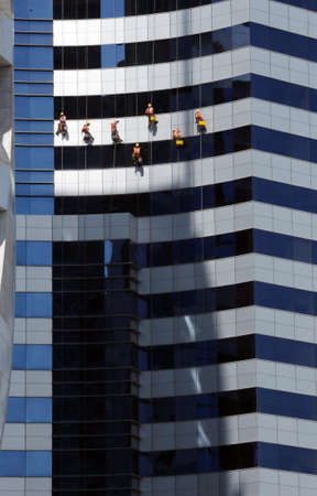 Workers washing windows of high rise building.の写真素材