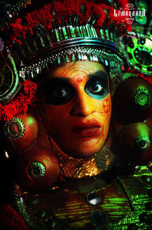 Hindu Goddess Durga face painted in orange and green colors.の写真素材