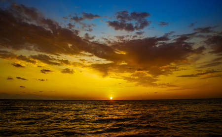 Beautiful sunset over the sea. The sun sets over the sea. The sun sets over the ocean.の写真素材