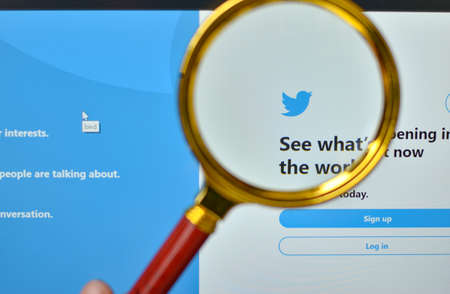 New York, USA, 2020. Twtitter logo & website signup page through a magnigying lens. Out of focus...