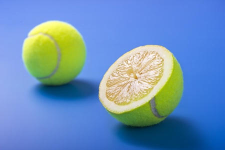 Lemon tennis balls on blue background.Focus in the foreground.の写真素材