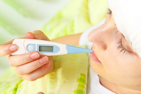 Woman being ill in bed and measuring body temperature with closed eyes Space on thermometer for...