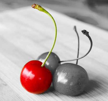 Close-up of a bunch of fresh red cherries on wooden table.Small depth of field.の写真素材